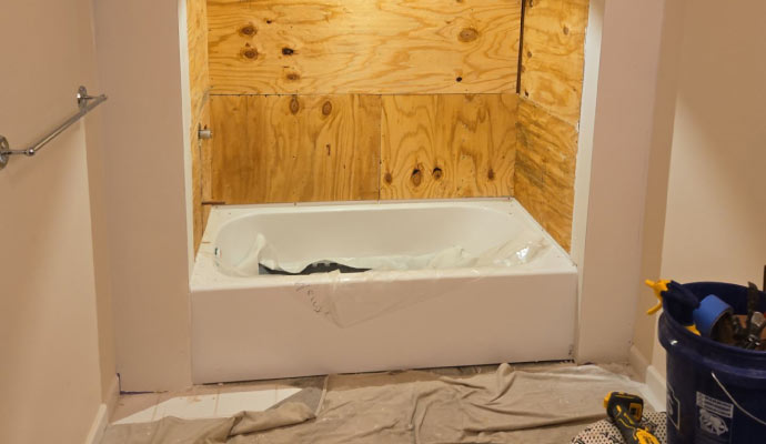 A renovated bathroom with a bathtub installed