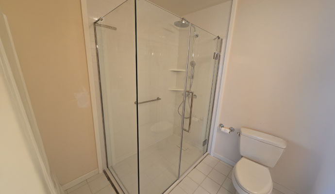 Modern bathroom with glass-enclosed shower and toilet