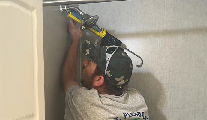 Professional installing shower in bathroom